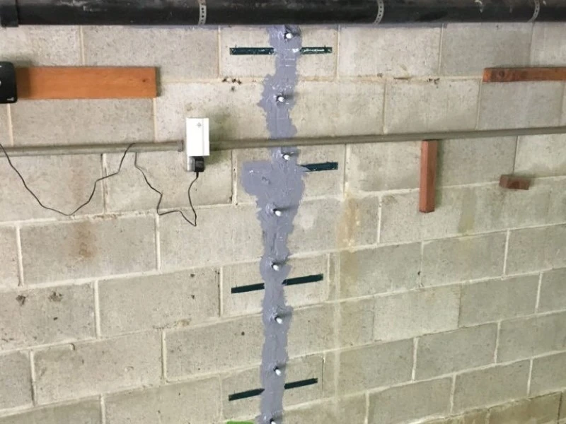 Carbon fiber strap installation for basement wall repair in Amarillo, TX