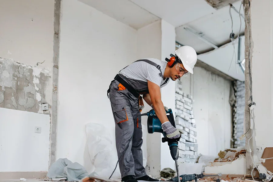 Foundation repair contractor breaking up concrete during slab replacement in Amarillo, TX
